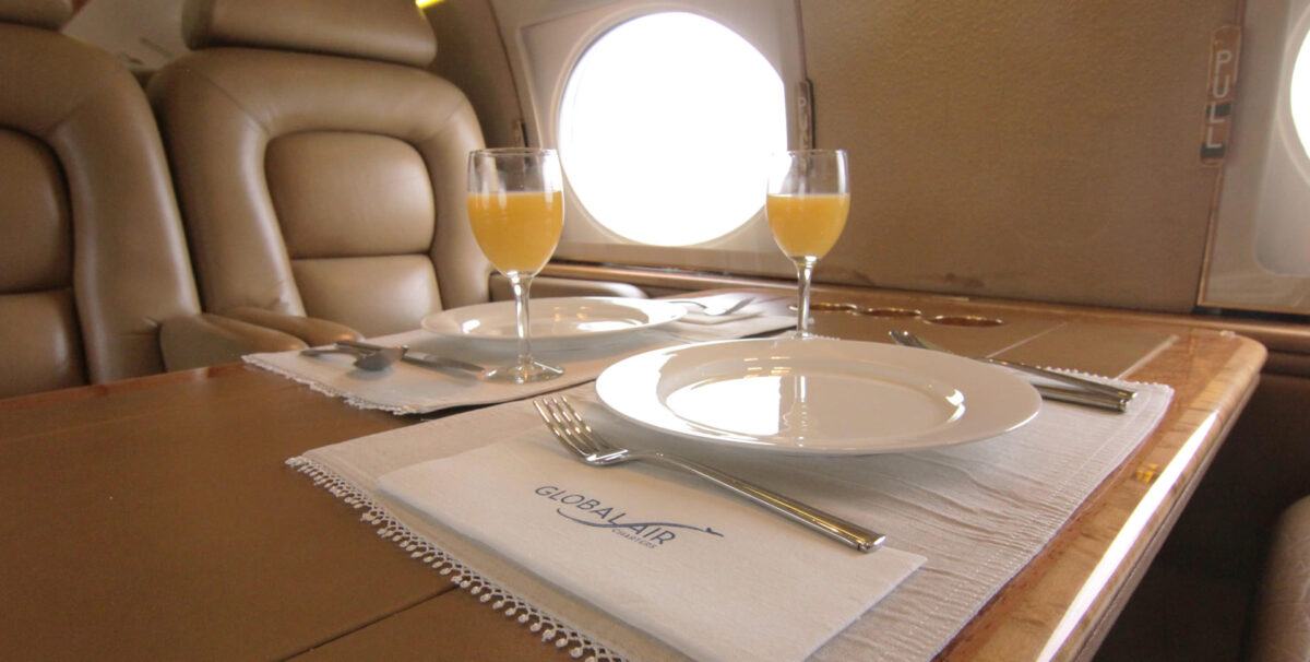 close up of place setting on private jet