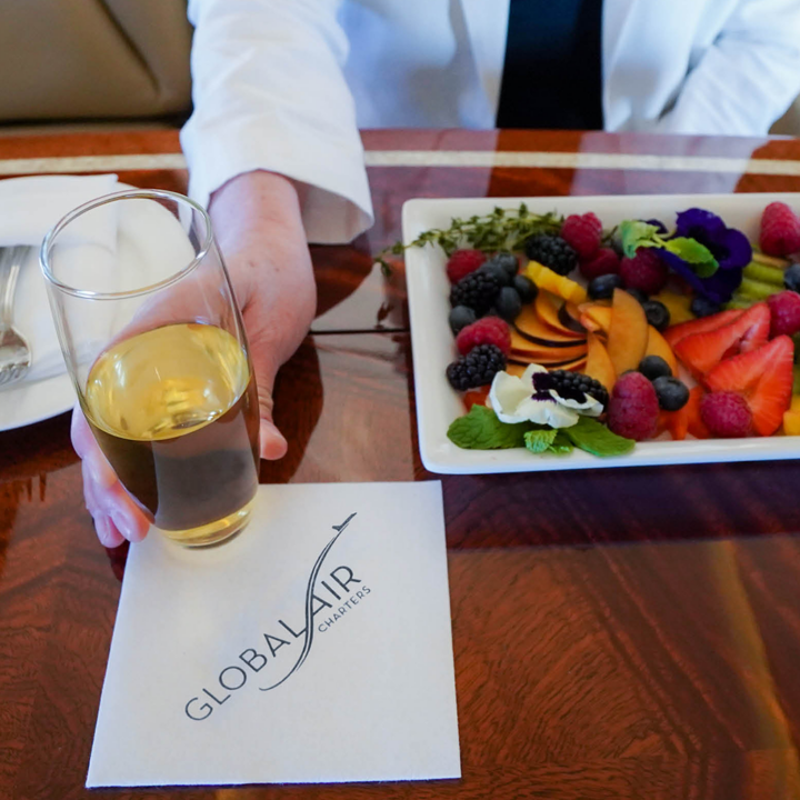 close up of food and beverage aboard private jet, how to charter a private jet