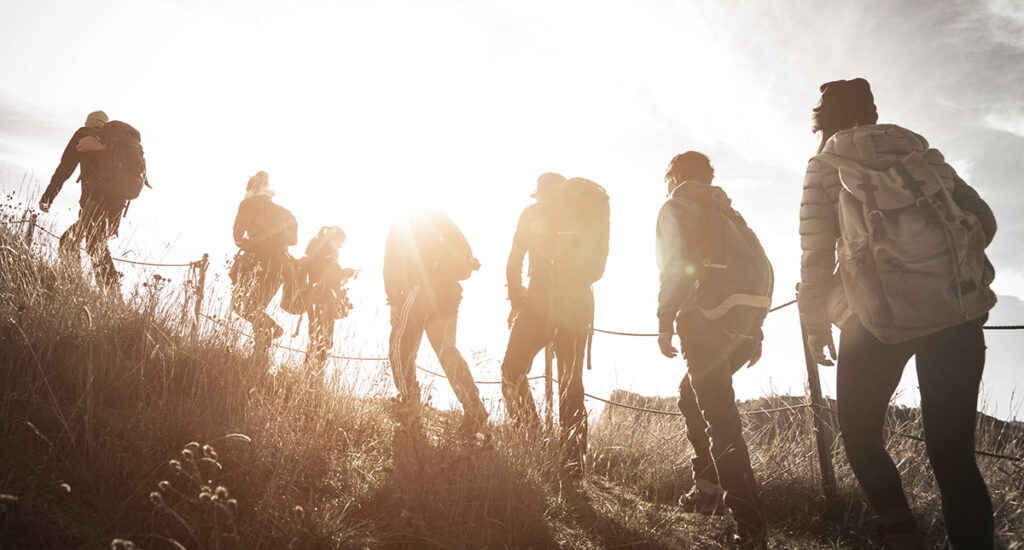 Group mountaineers using technical climbing skills for their adventure travel resolutions