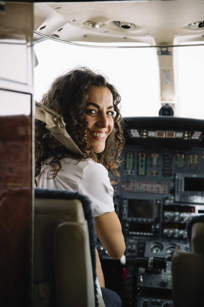 Brunette woman pilot navigating plane, crew training