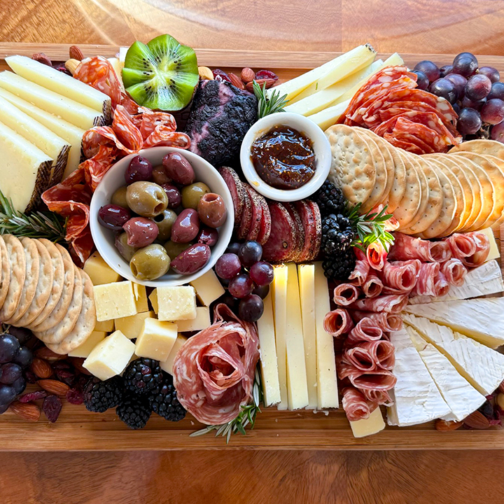 compilation of cold cuts, cheeses, fruits, and crackers served on private jet